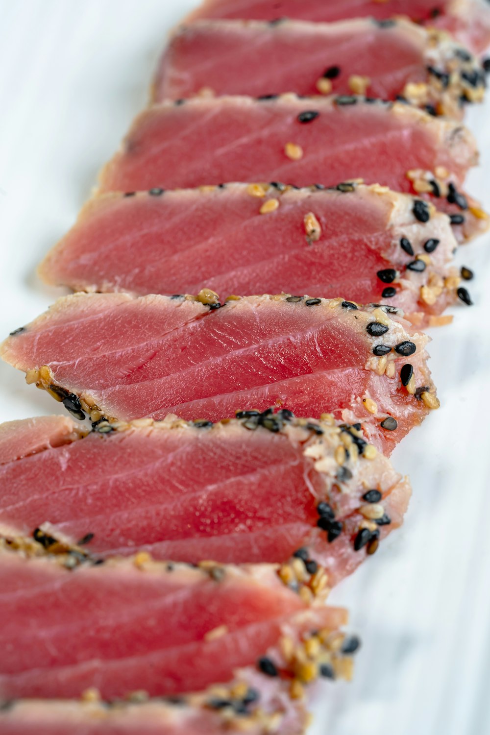 sliced raw meat on white ceramic plate