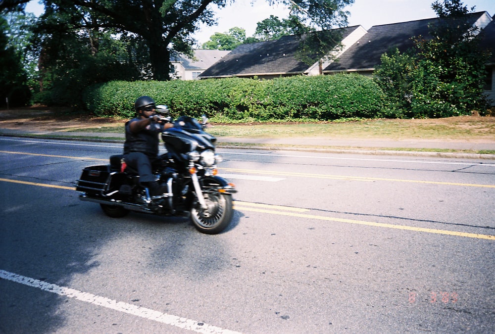 man in black jacket riding motorcycle on road during daytime