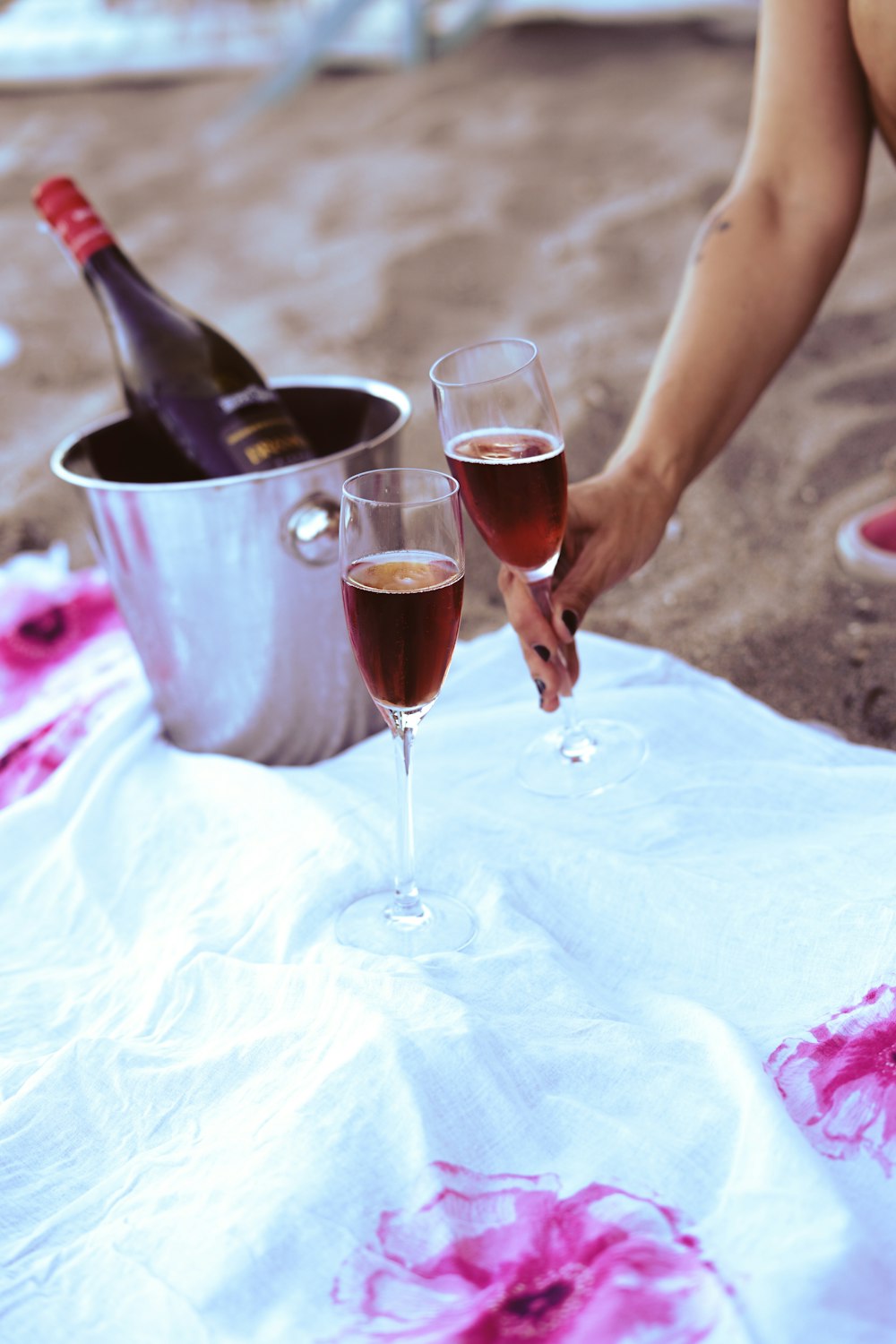 person pouring wine on wine glass