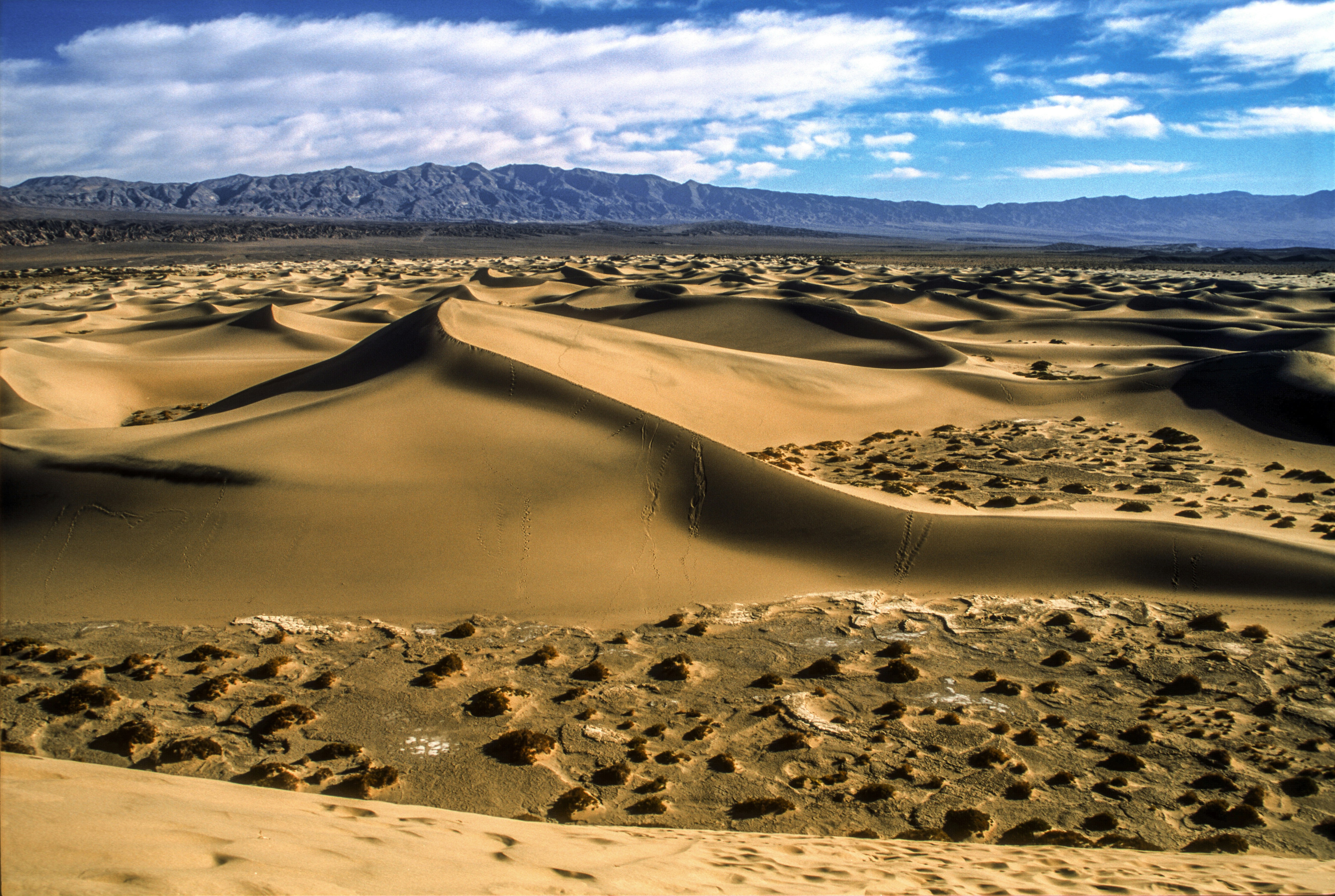 brown sand field under blue sky during daytime, I moved across the country in 2005 and the first place I went to while moving out of California was Death Valley. So stark and amazing. | Shot on Fuji Provia slide film, Canon A2E, scanned on Nikon CoolScan 4000