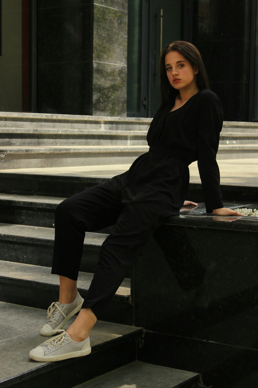 Foto Mujer con camisa negra de manga larga y sentada en un banco de hormigón – Imagen Mujer en Unsplash