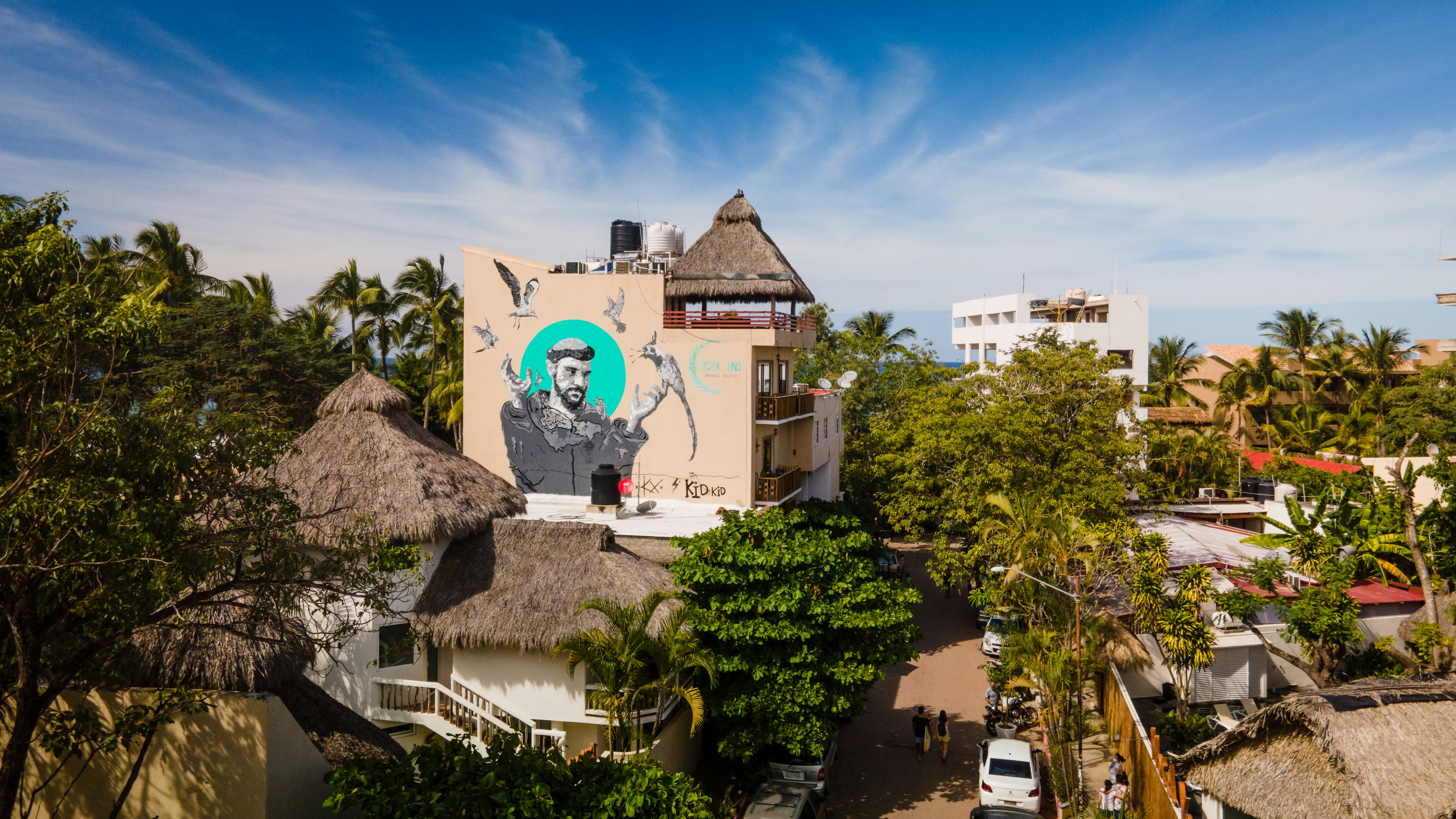 white concrete building near green trees during daytime