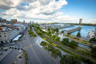 cars on road near city buildings during daytime