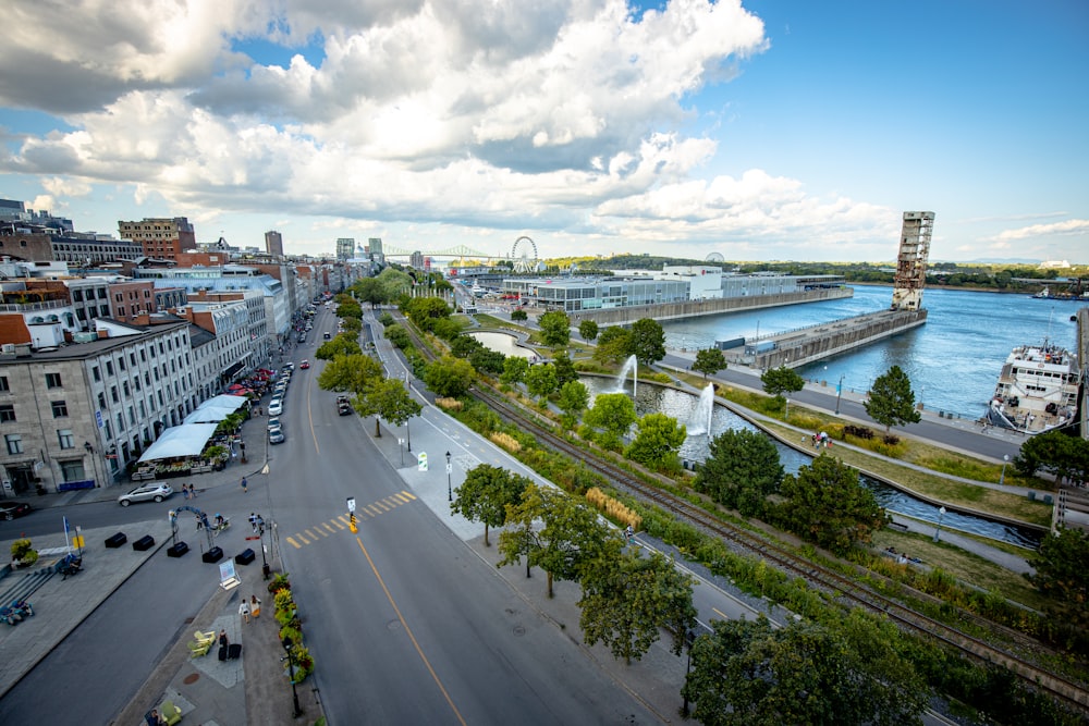 cars on road near city buildings during daytime