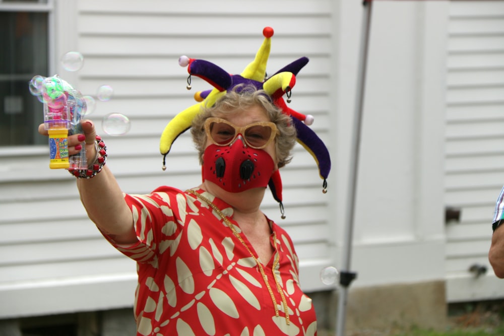 girl in red and white polka dot shirt with red mask