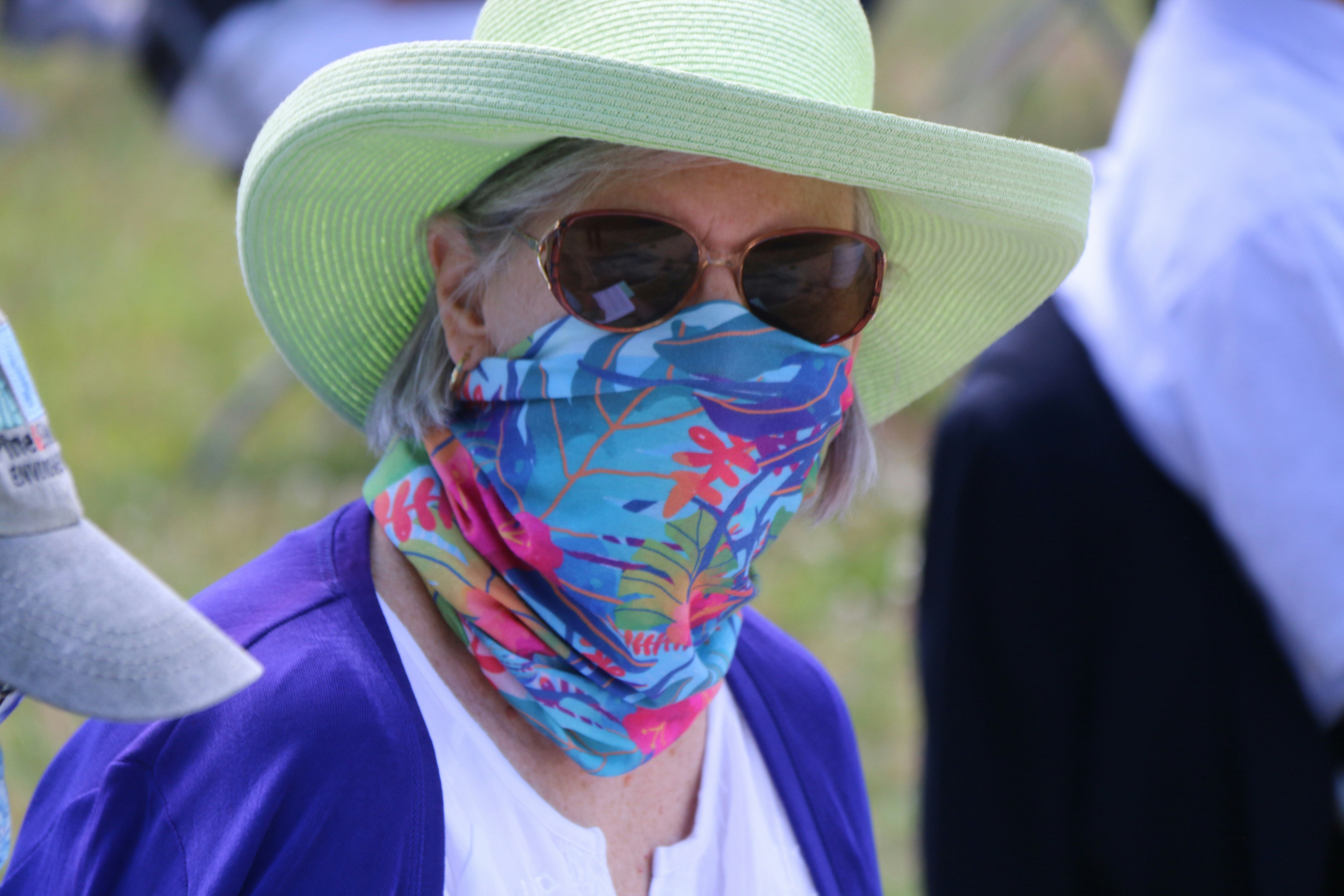 woman in blue and white scarf and white shirt wearing brown hat