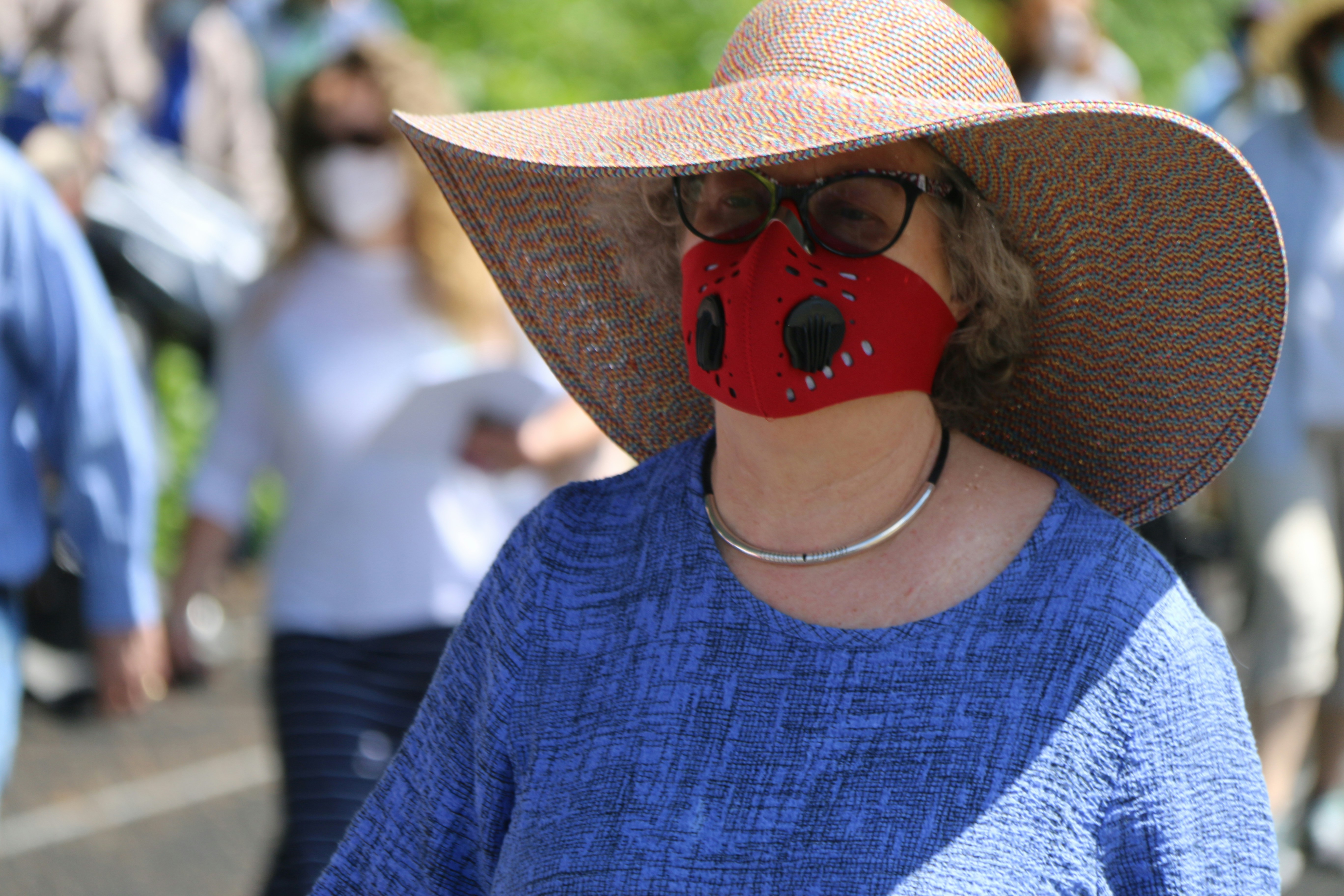 person wearing brown sun hat and blue crew neck shirt