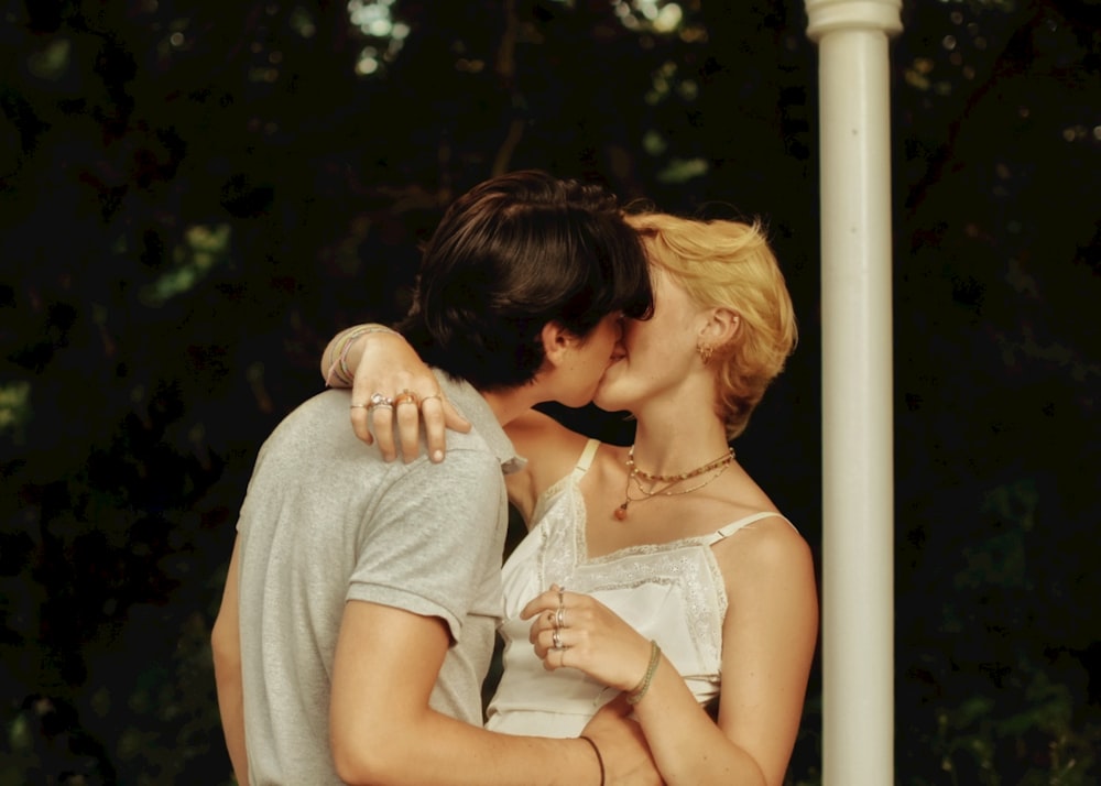 woman in white dress kissing woman in white dress