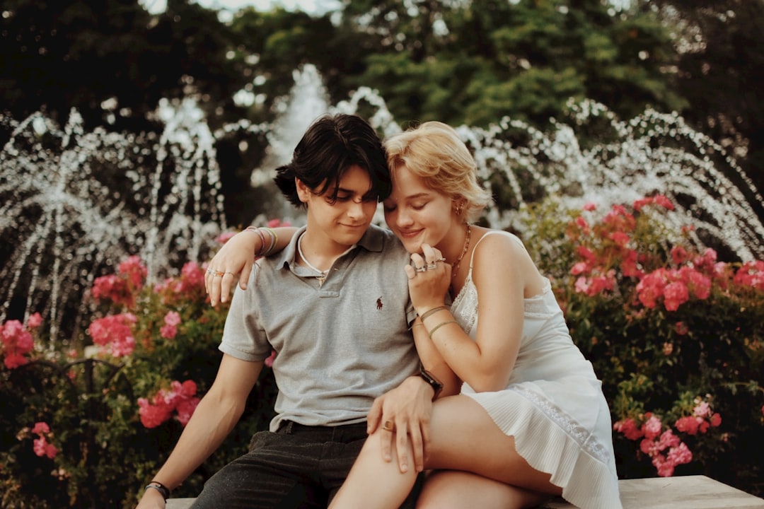 woman in white dress sitting on mans lap