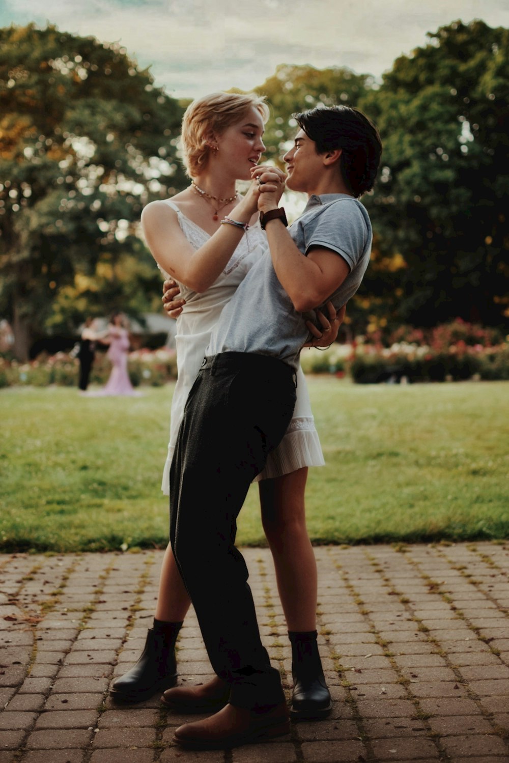 woman in white shirt and black skirt carrying baby in white shirt