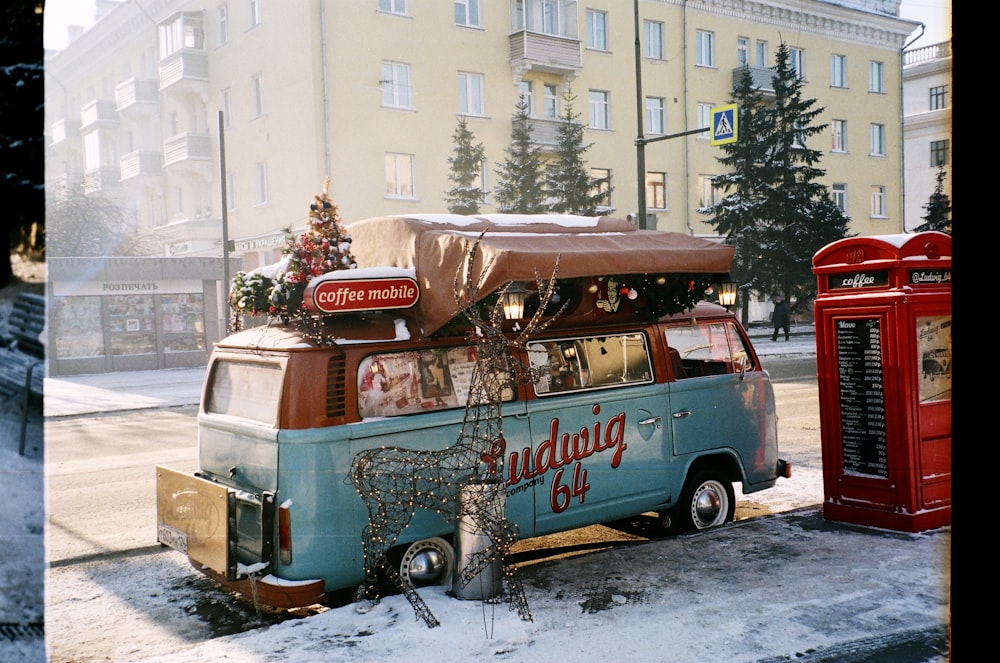 blue and white volkswagen t-2 van on snow covered ground during daytime