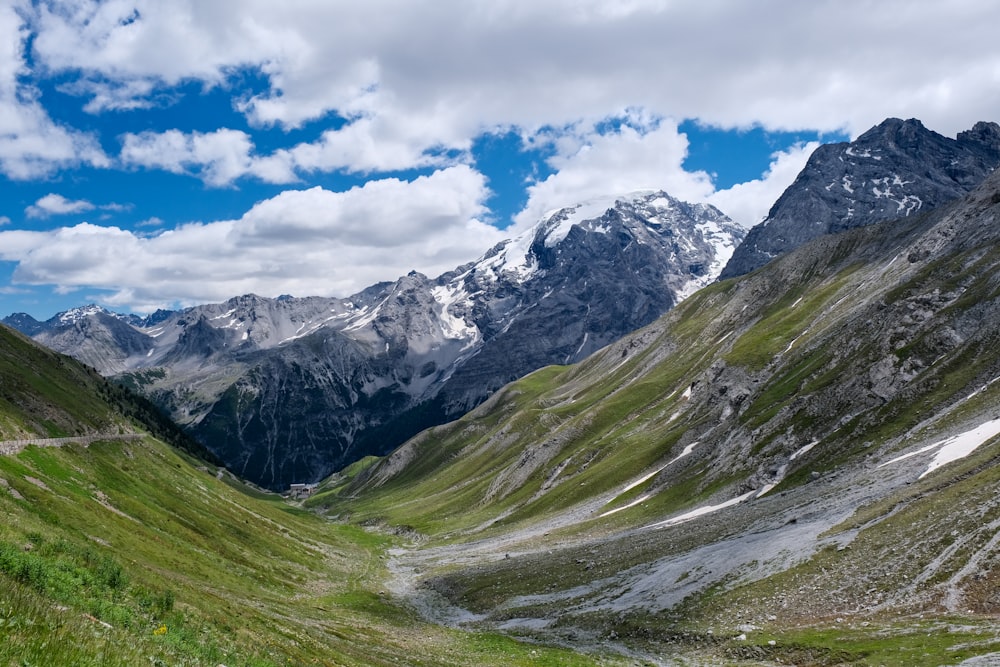 green and white mountains under blue sky and white clouds during daytime