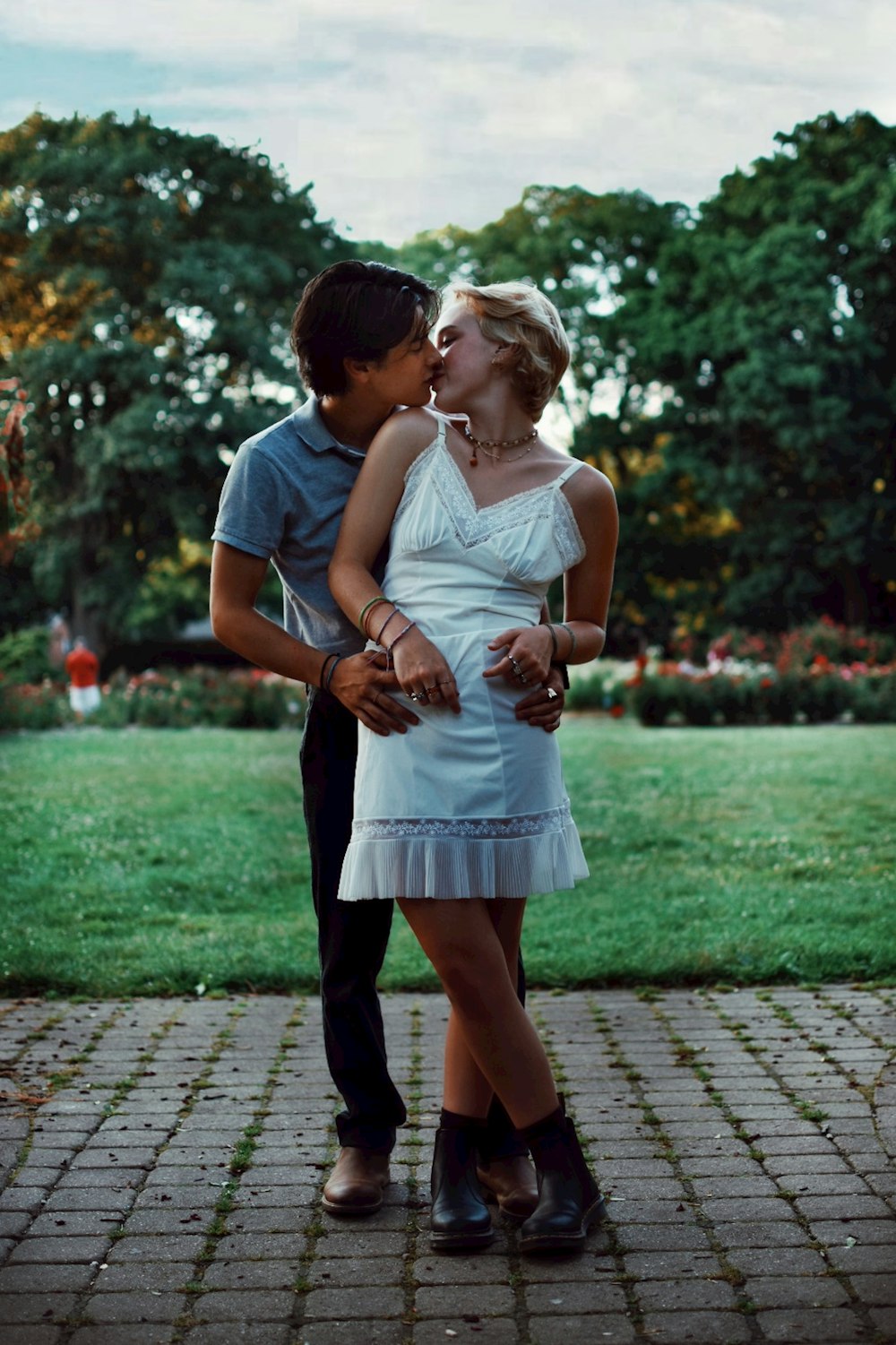 woman in white dress hugging man in white t-shirt