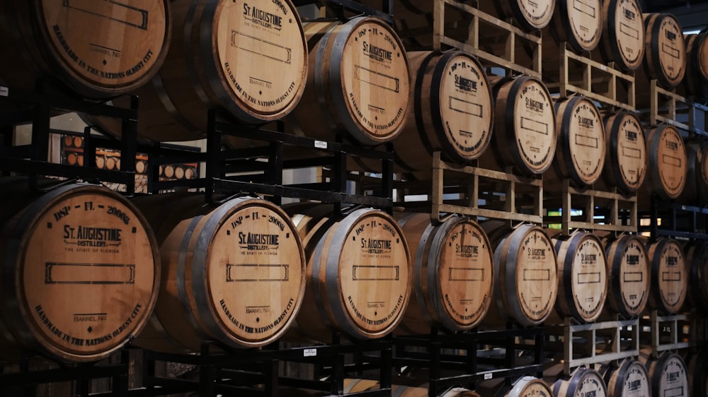 brown wooden barrels on rack