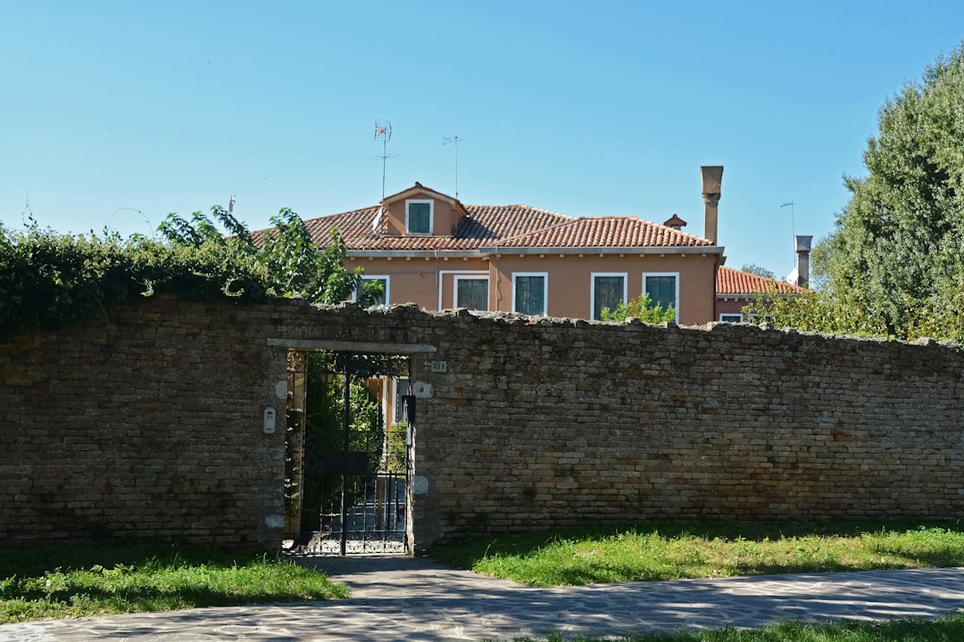 brown brick building near green trees during daytime