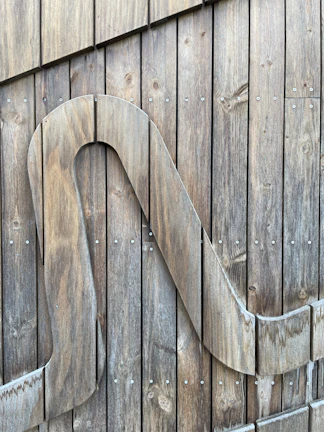 Custom wood carving of a personalized nameplate with smooth finish.