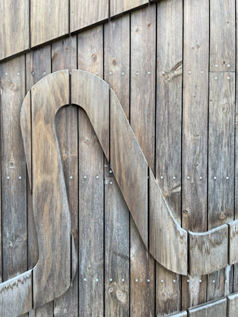 Custom wood carving featuring a personalized family name sign with smooth finishes.