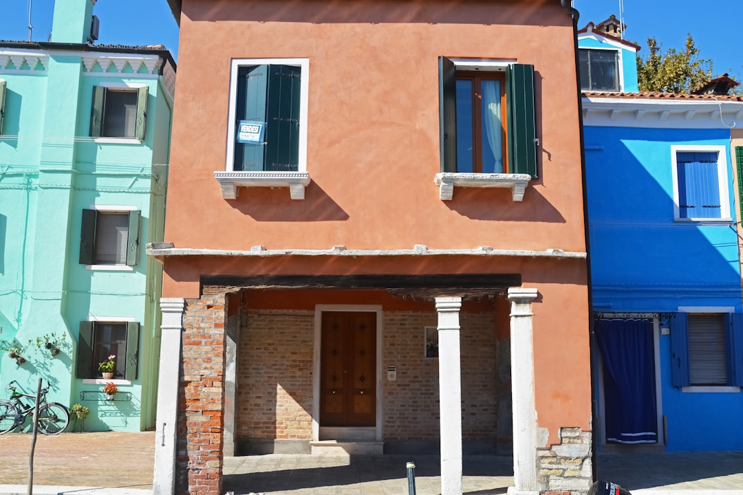 brown concrete building with blue window