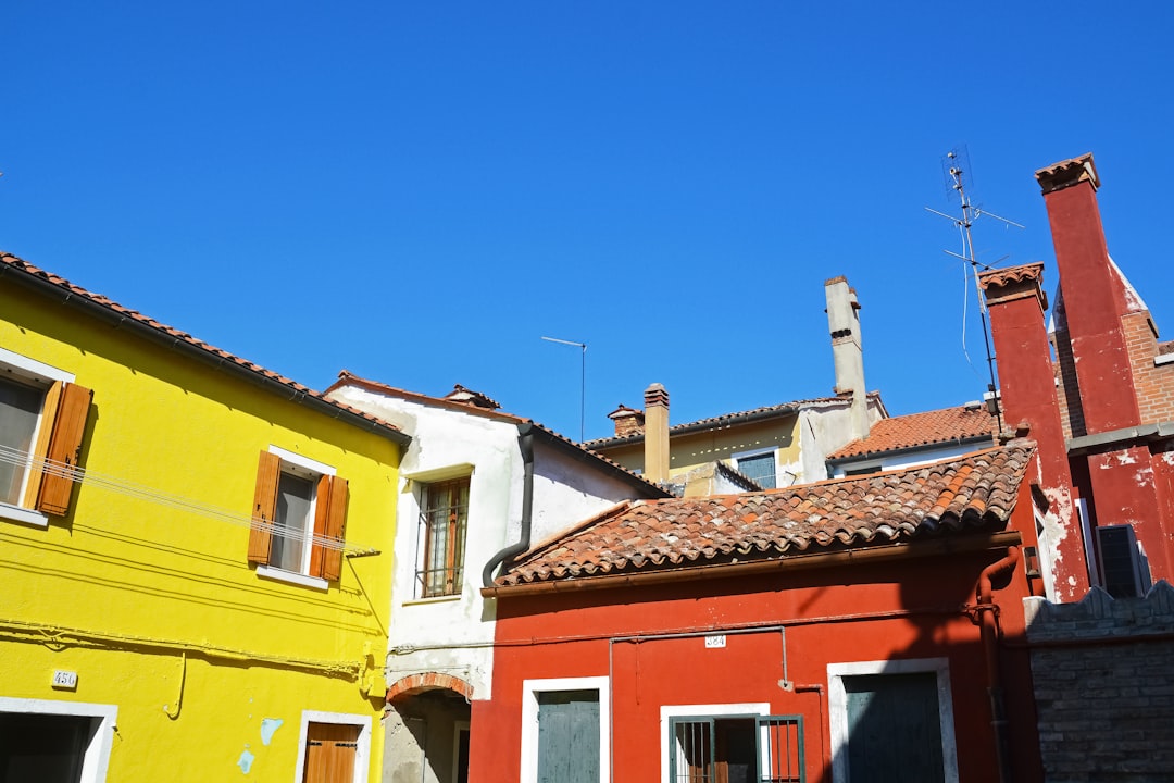 yellow and red concrete building under blue sky during daytime