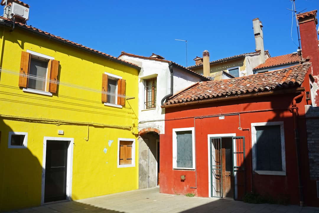 yellow and red concrete house under blue sky during daytime