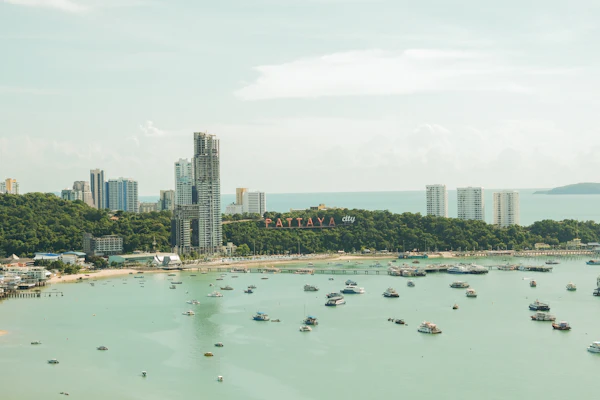 Boats scattered across Pattaya Bay beside the beachfront