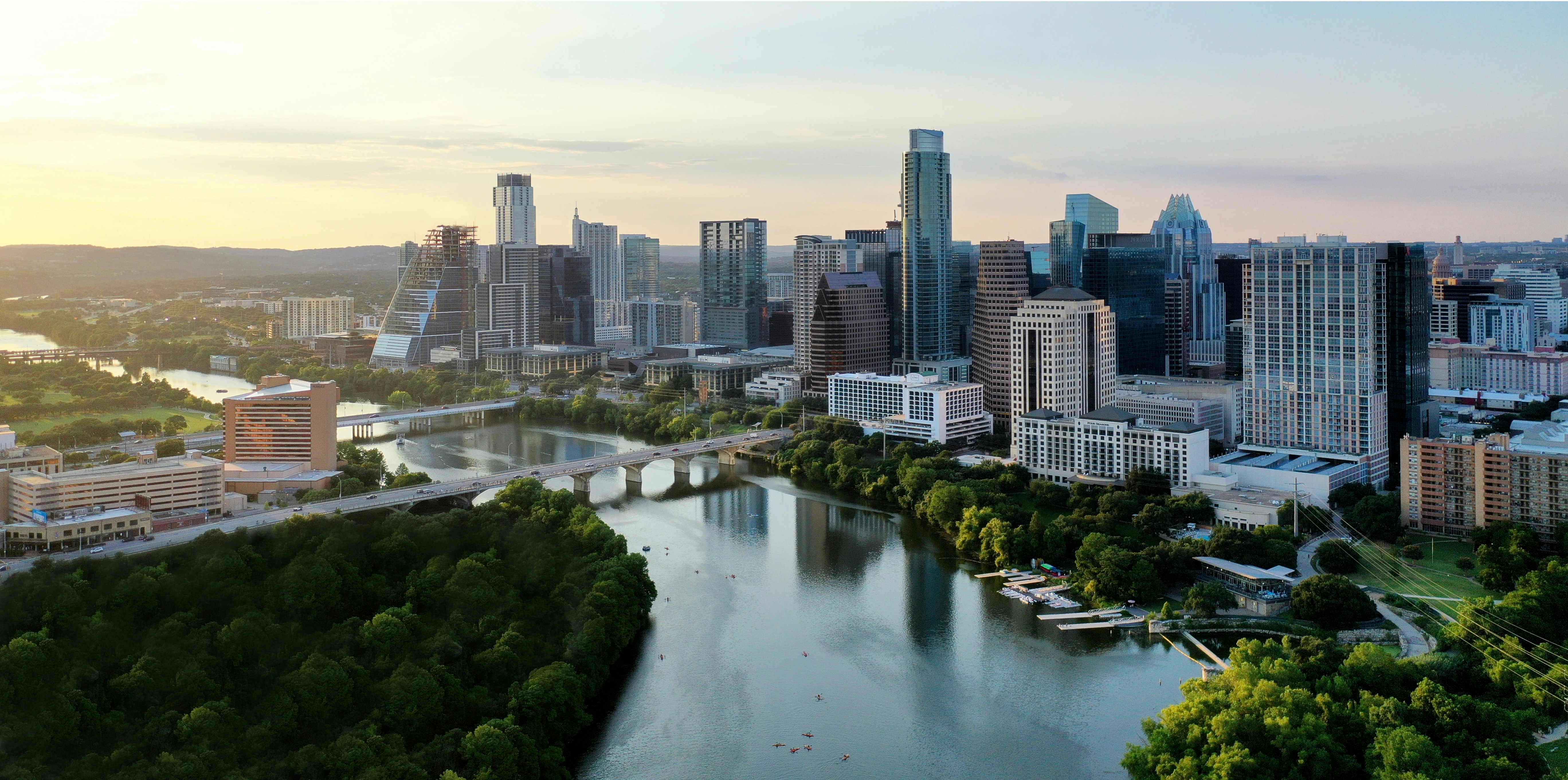 Downtown Austin skyline over Lady Bird Lake and Town Lake Trail at sunset.