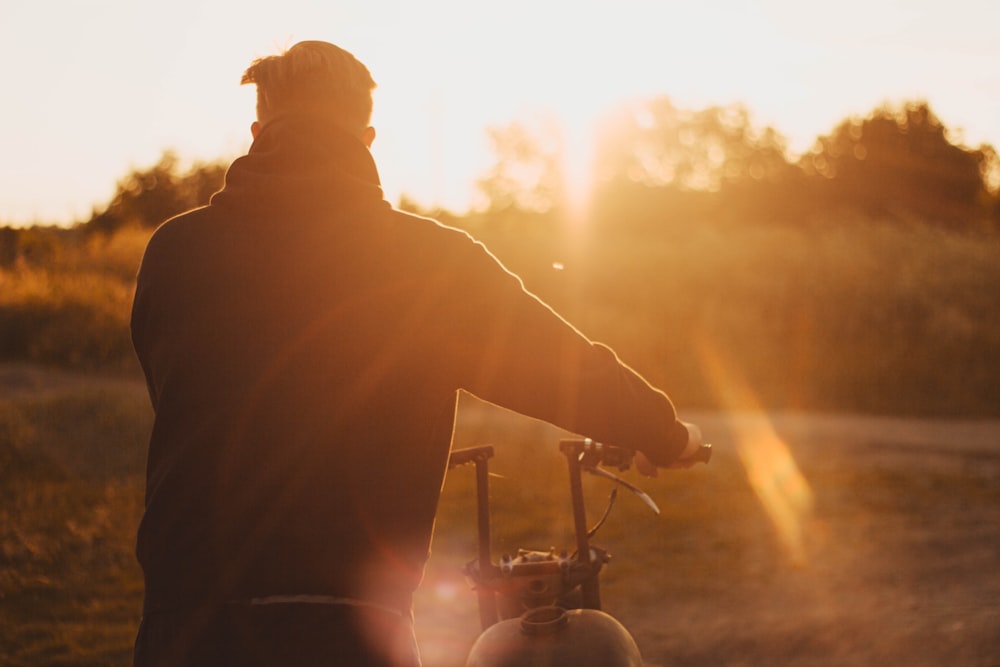 silhouette of man riding motorcycle during sunset