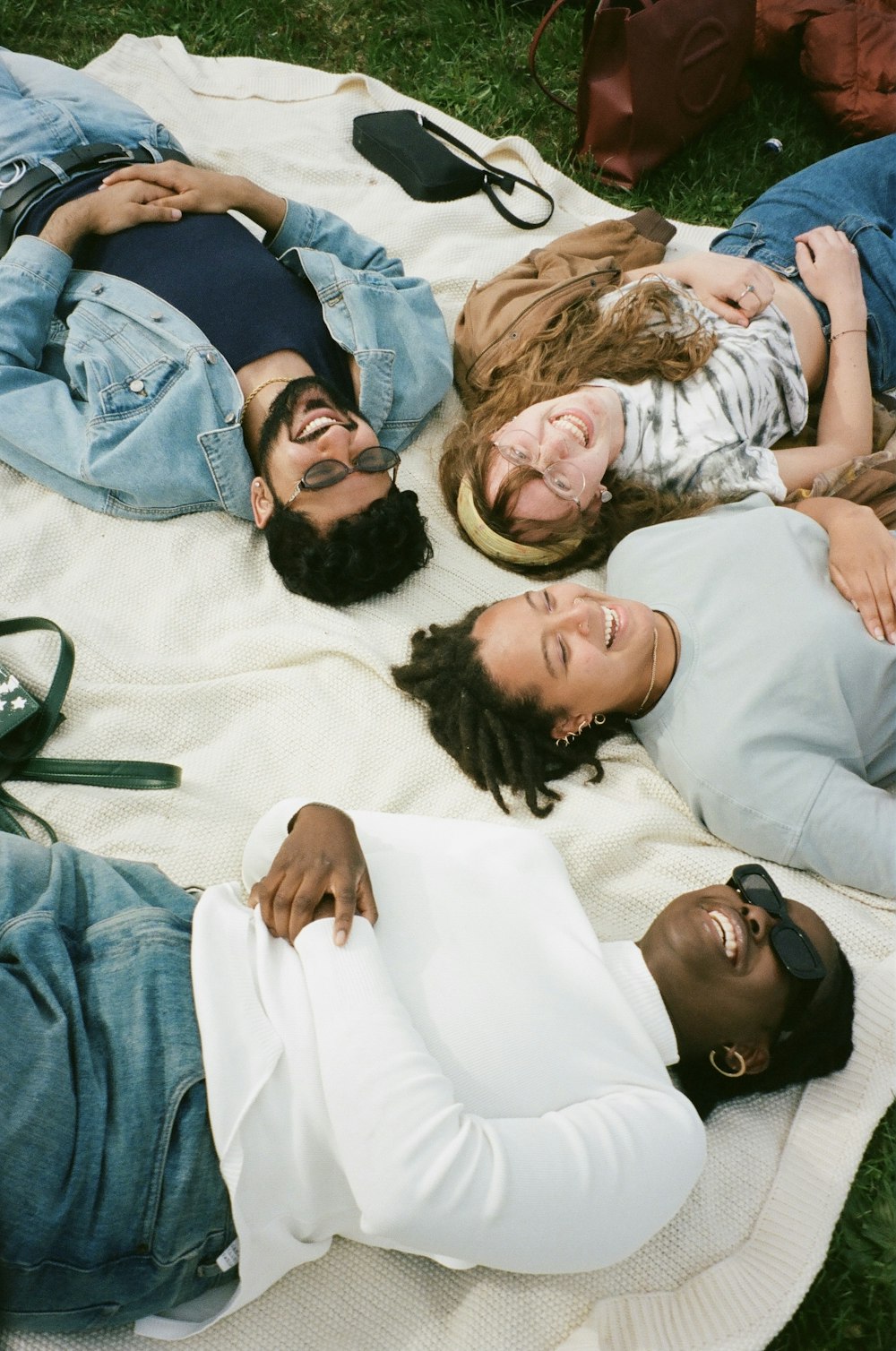 man in blue button up shirt lying on white bed