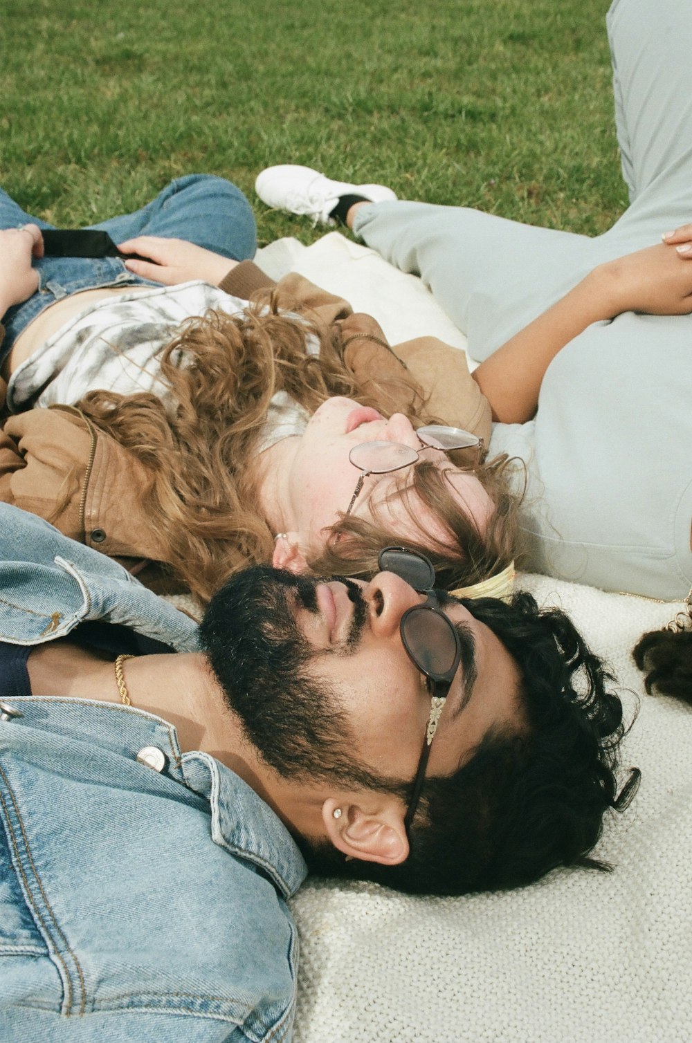 man and woman lying on white textile