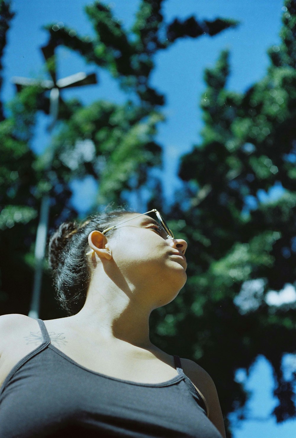 woman in white tank top wearing sunglasses during daytime