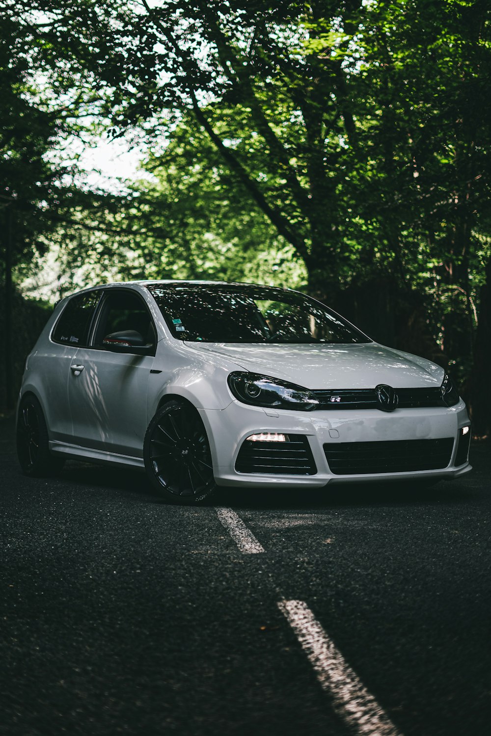 white bmw m 3 coupe parked on black asphalt road during daytime