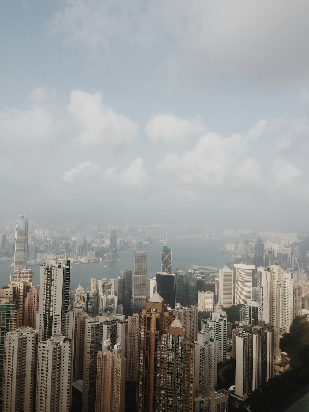 city skyline under white clouds during daytime