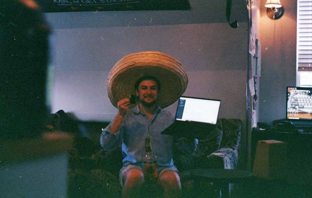 girl in blue jacket and brown sun hat sitting on couch