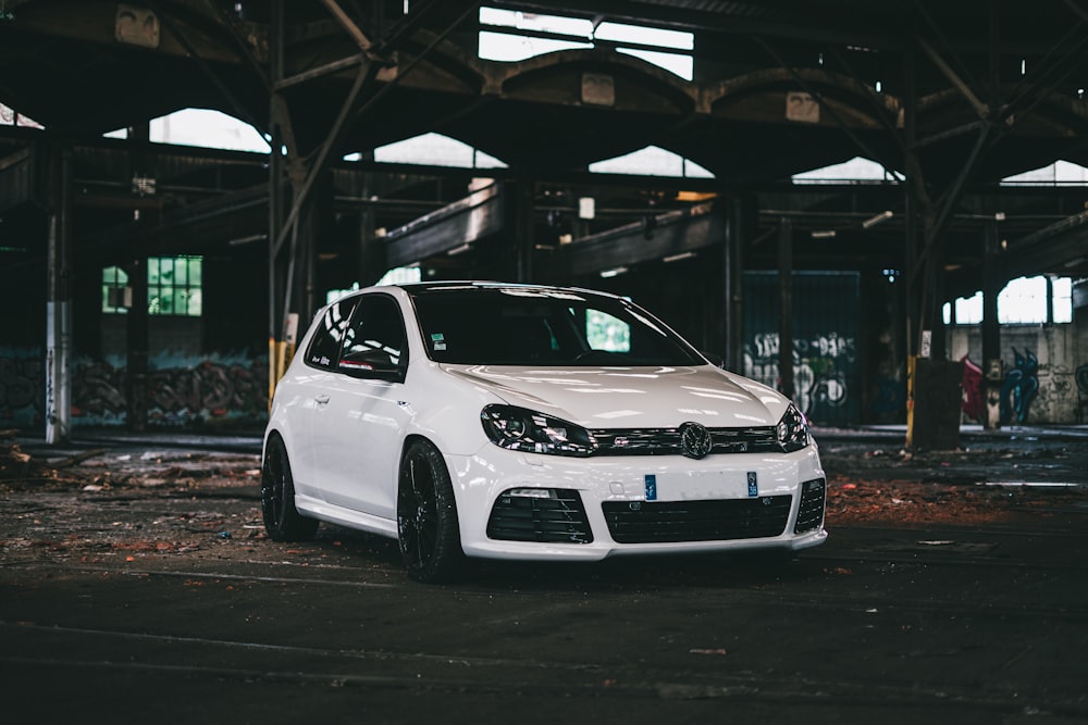 white bmw m 3 parked on parking lot during night time