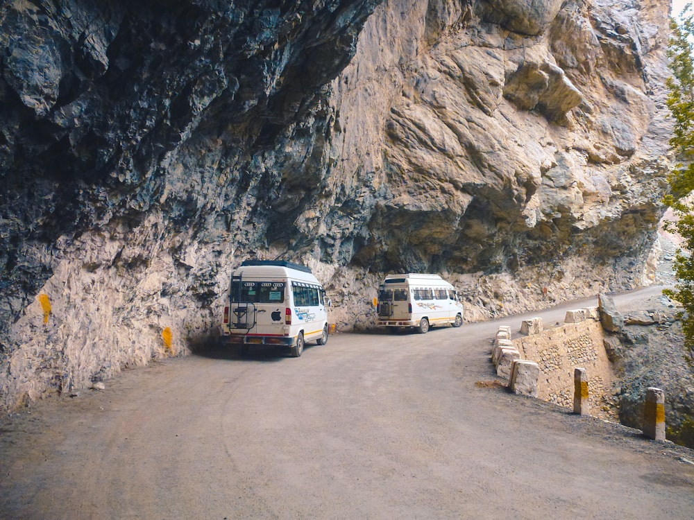 white van on road near rocky mountain during daytime