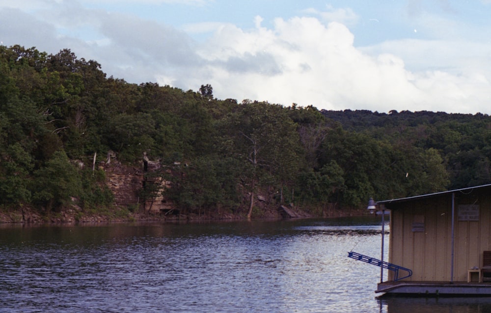 boat on lake near green trees during daytime