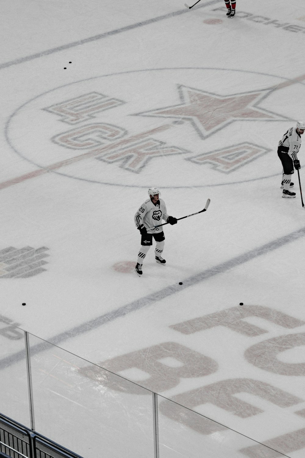 2 men playing ice hockey