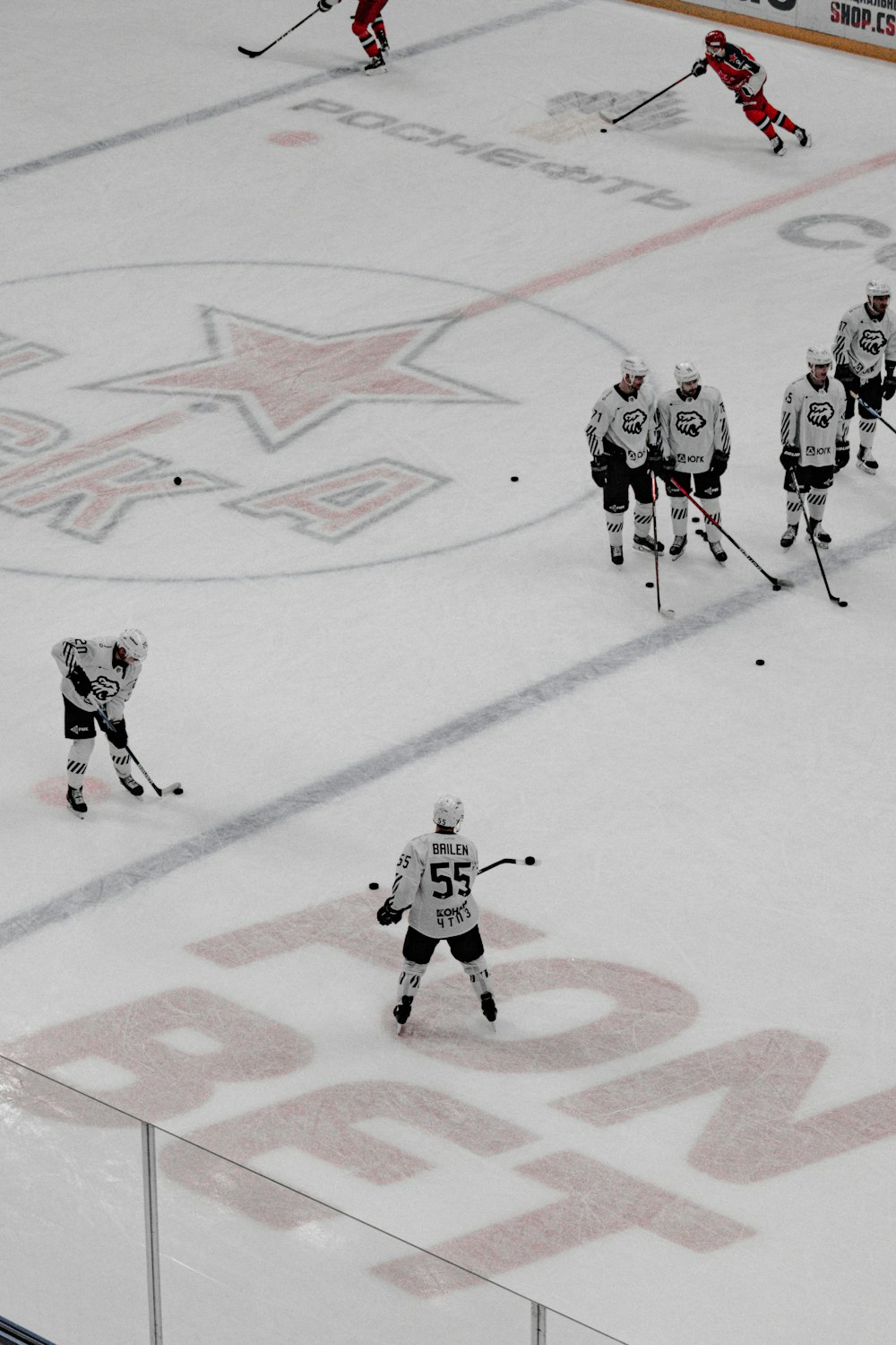 people playing ice hockey on ice field