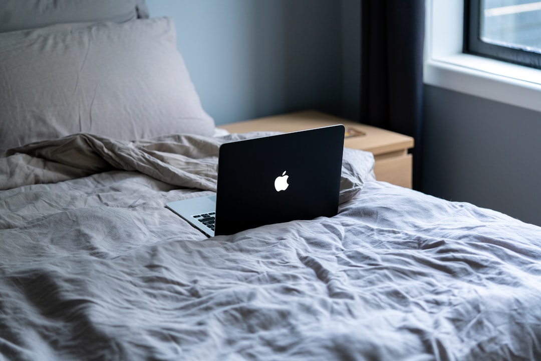 macbook air on white bed