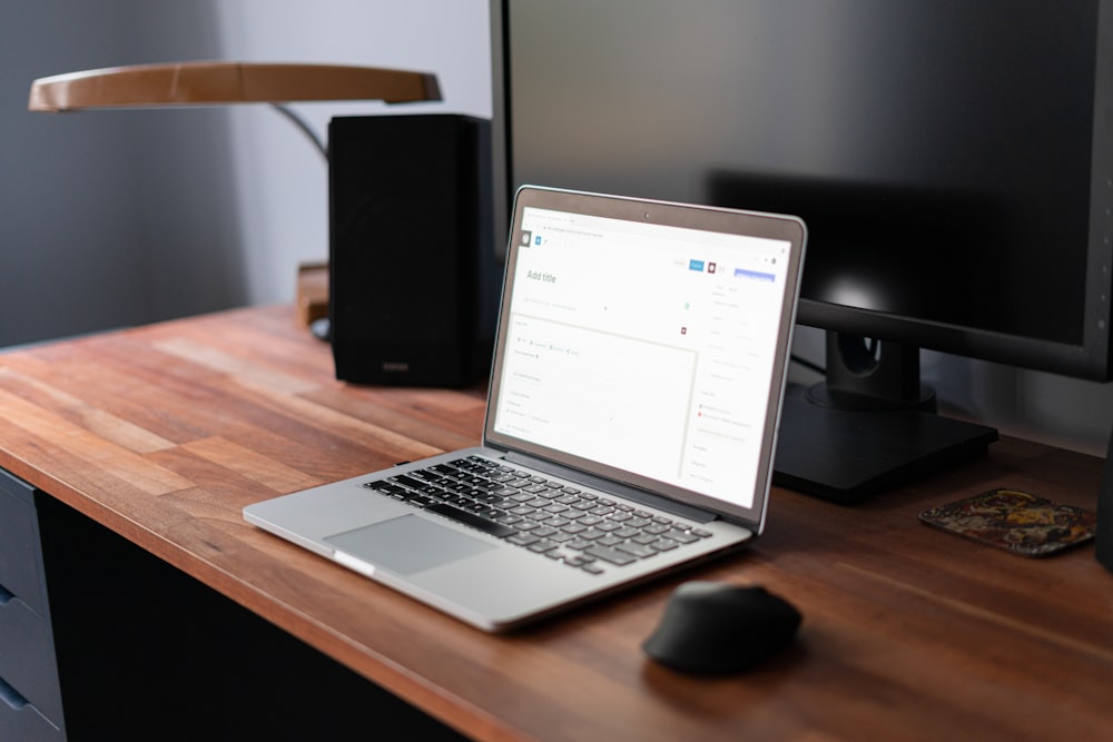 macbook pro on brown wooden table