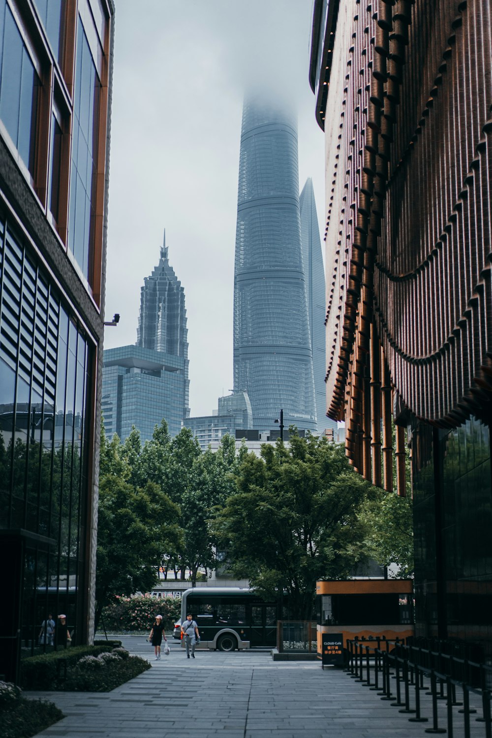 cars parked in front of high rise building during daytime