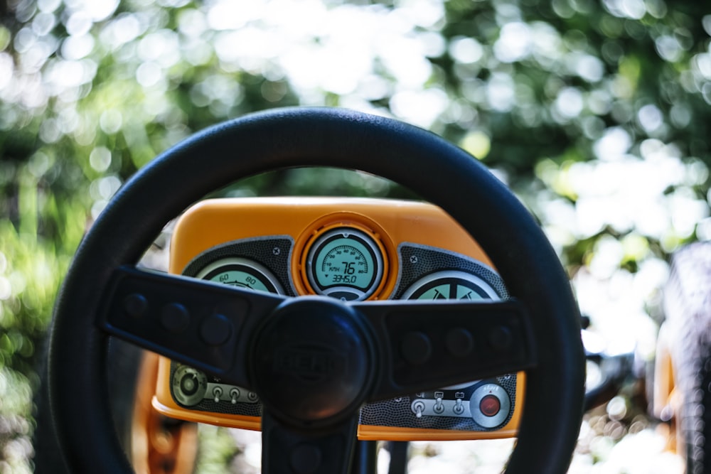 black steering wheel with yellow and black camera lens