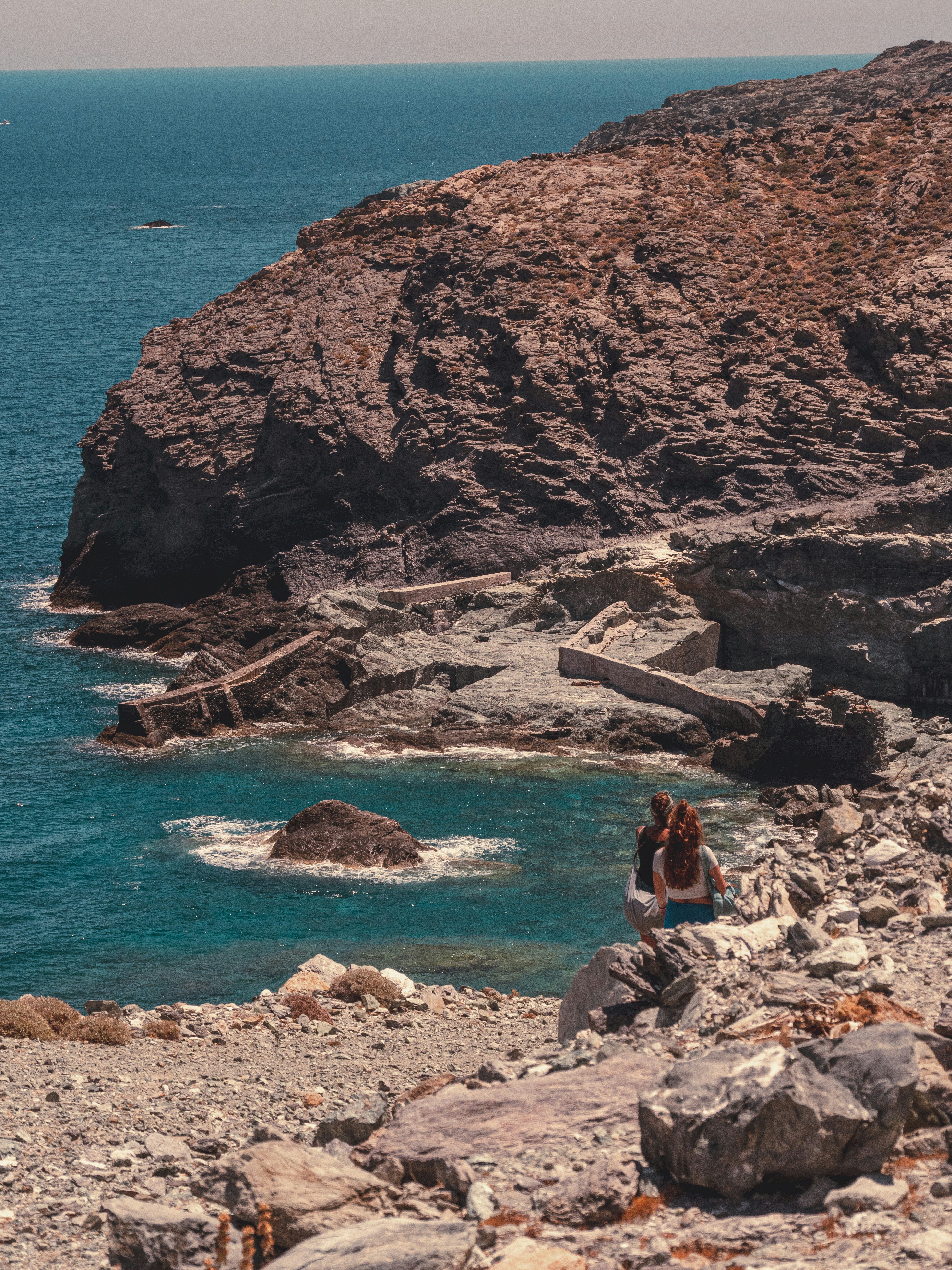 Women walk near seashore 