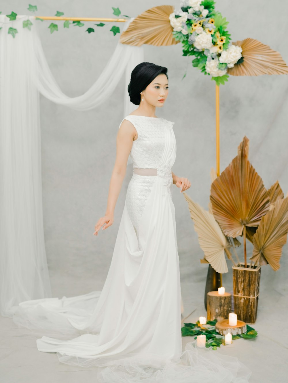 woman in white wedding dress holding bouquet of flowers