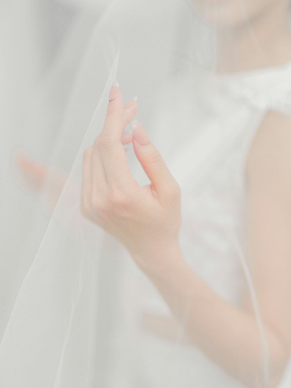 woman in white dress holding white textile