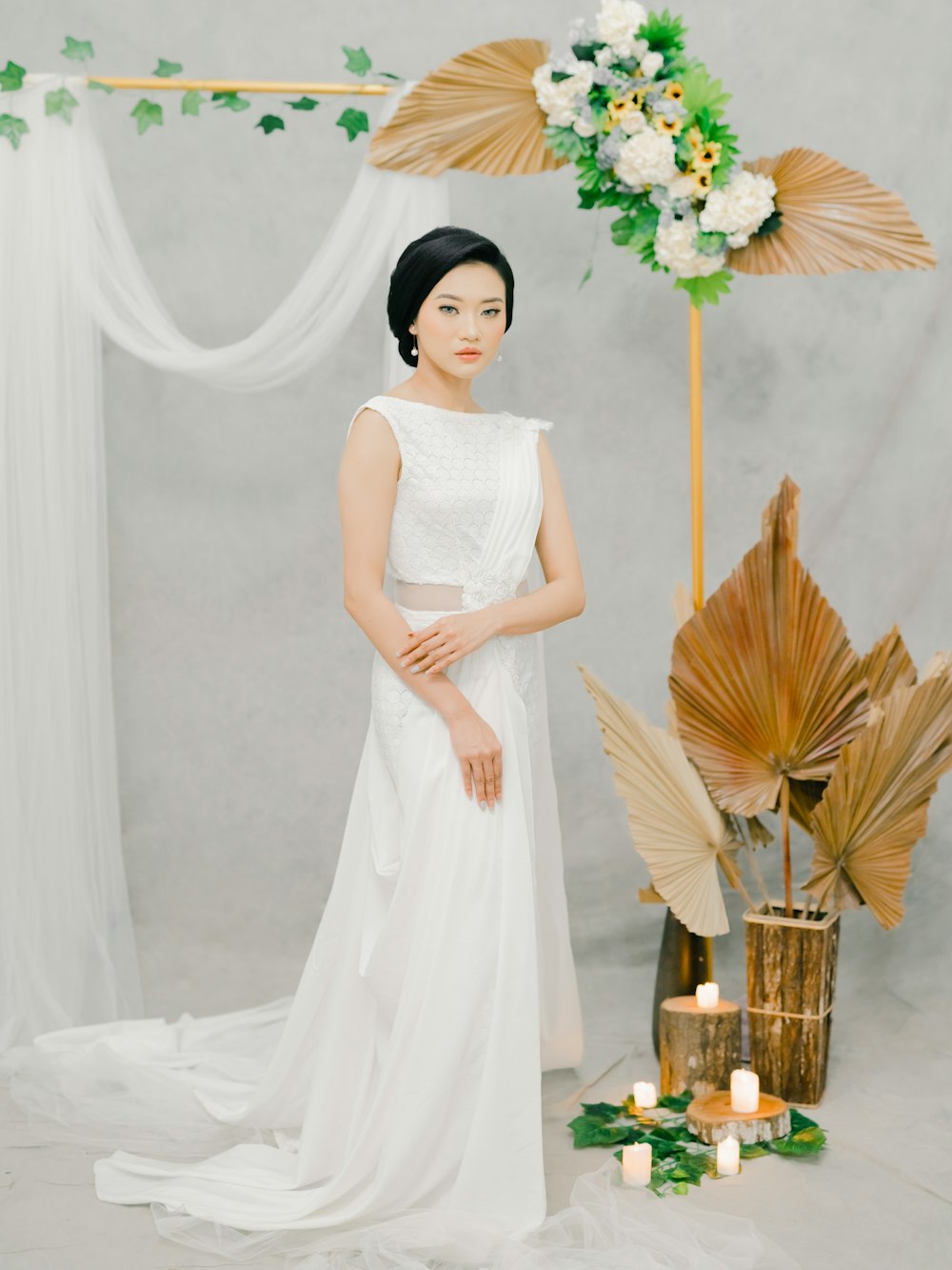 woman in white sleeveless dress holding brown woven basket