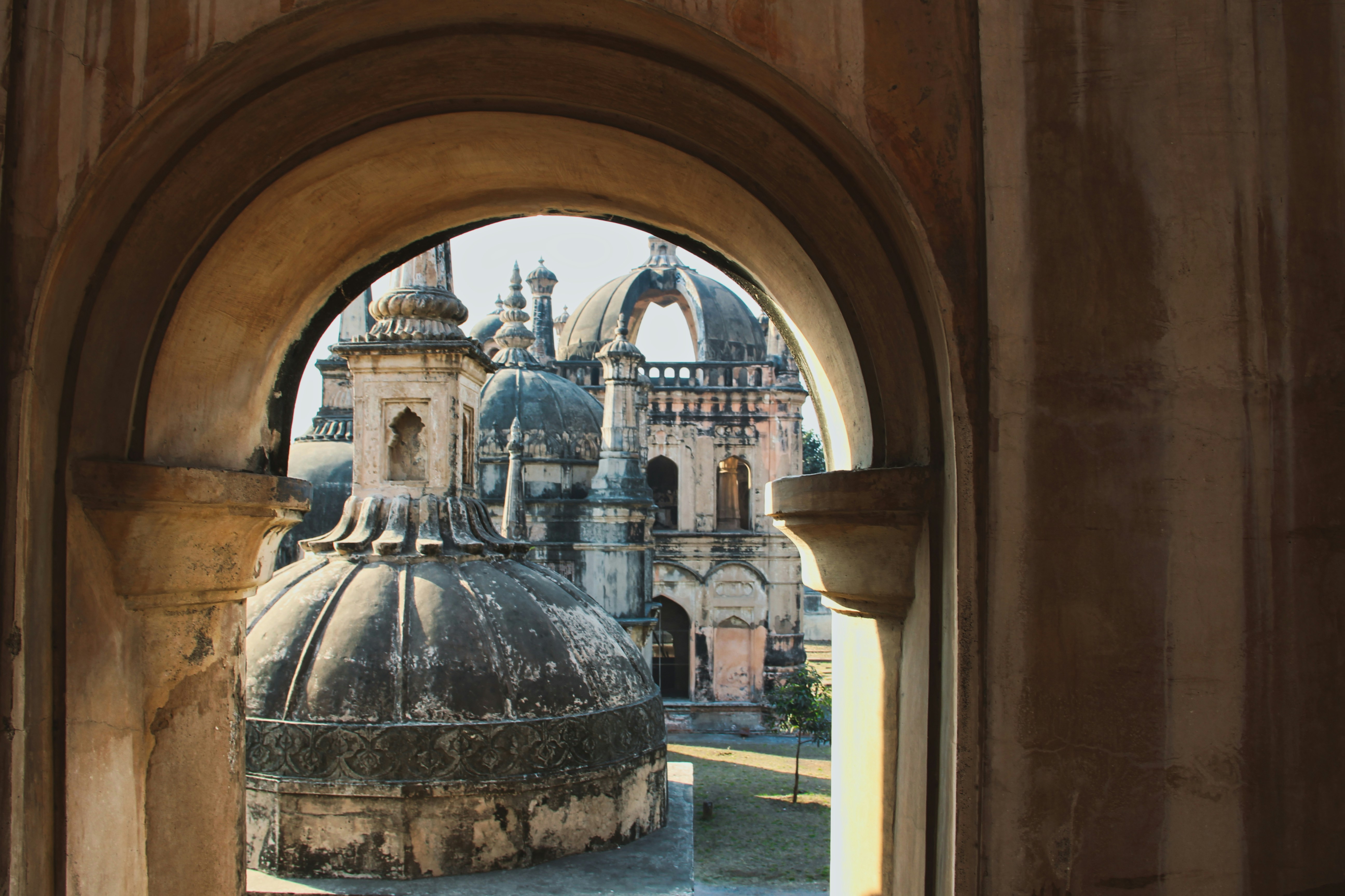 The tombs of some important persons in the history of Surat city at the Dutch Cemetery, seen through an arc.