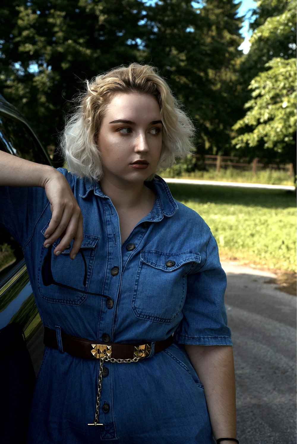 girl in blue denim button up jacket and brown leather belt