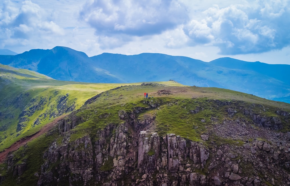 person standing on rock mountain during daytime