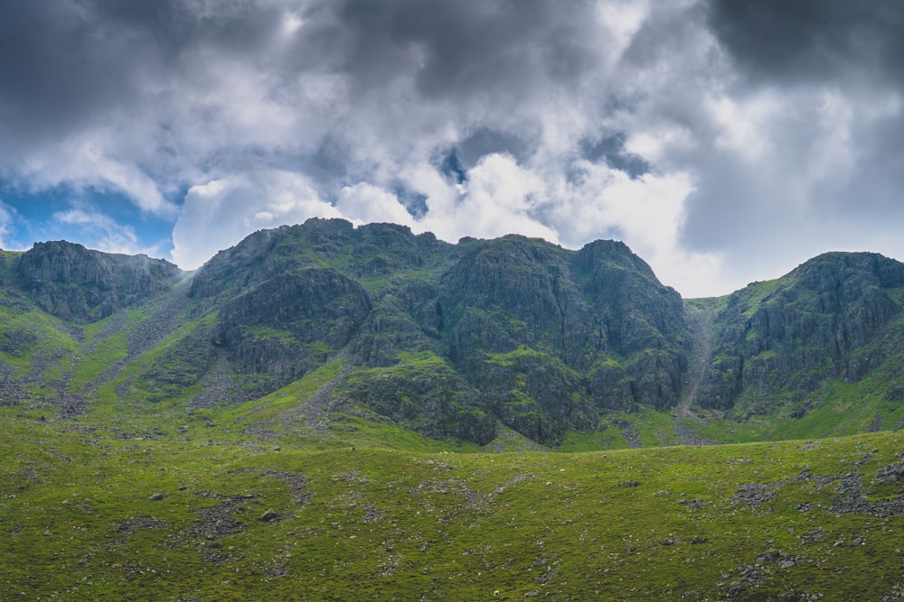 green mountain under white clouds during daytime